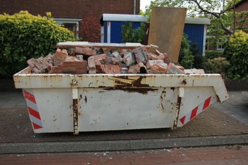 Workers sorting recyclables at a skip in Poplar