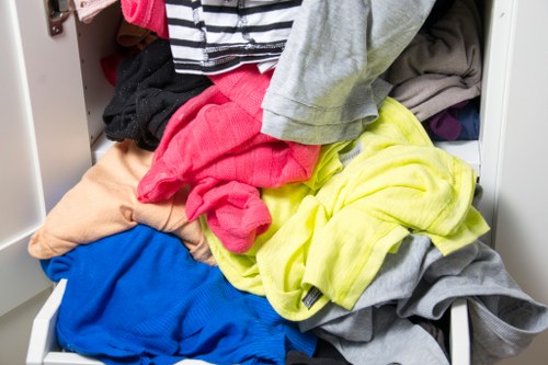 Operator checking a skip and vehicle GPS during waste collection